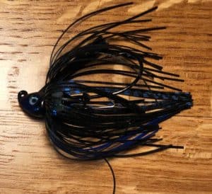 blue and black skirted bass fishing jig