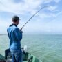 andrew juran-reeling-in-fish-with-saltwater-fishing-rod
