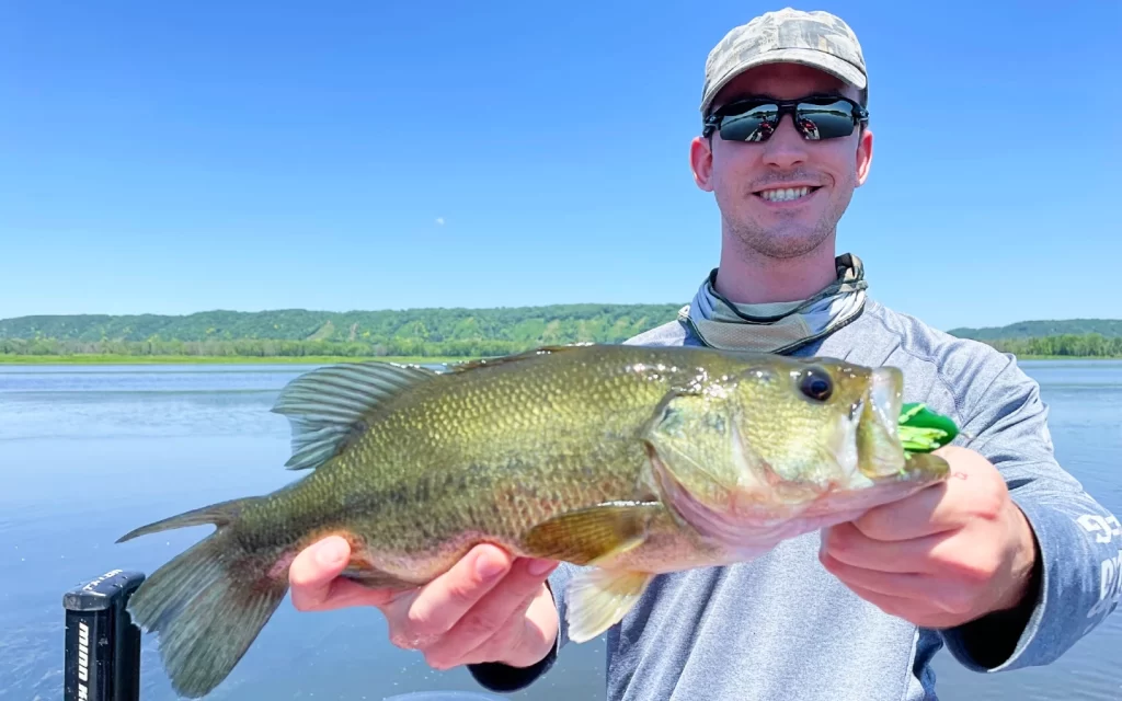 andrew juran holding largemouth bass caught with frog
