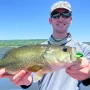 andrew juran holding largemouth bass caught with frog
