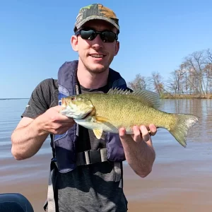 andrew juran holding smallmouth-bass-caught-in-dirty-water