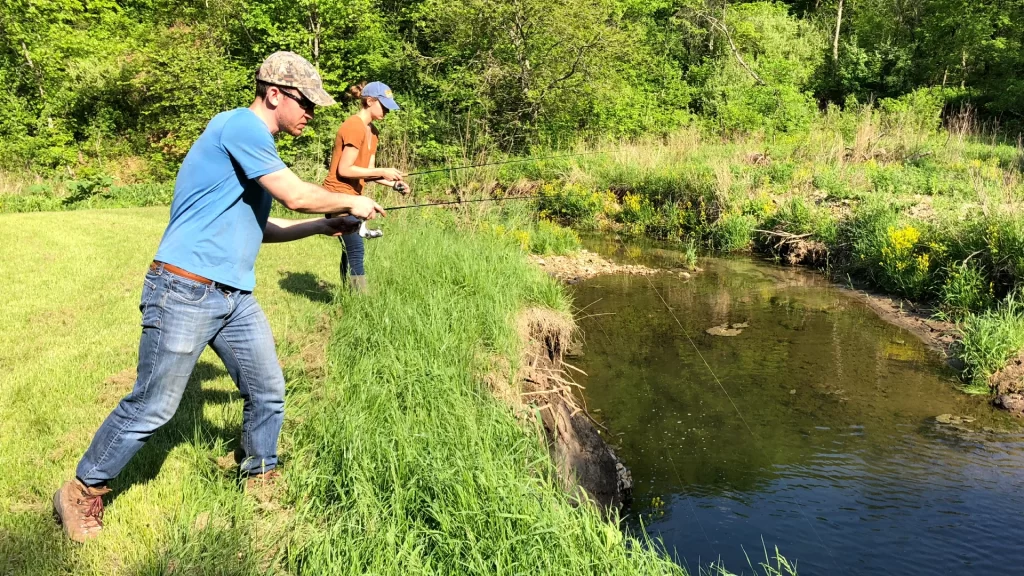 andrew juran and ornella juran using ultralight fishing rods trout fishing in creek