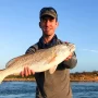 andrew juran holding redfish caught inshore fishing