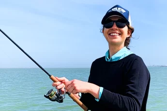 ornella juran holding spinning rod and reel combo saltwater fishing