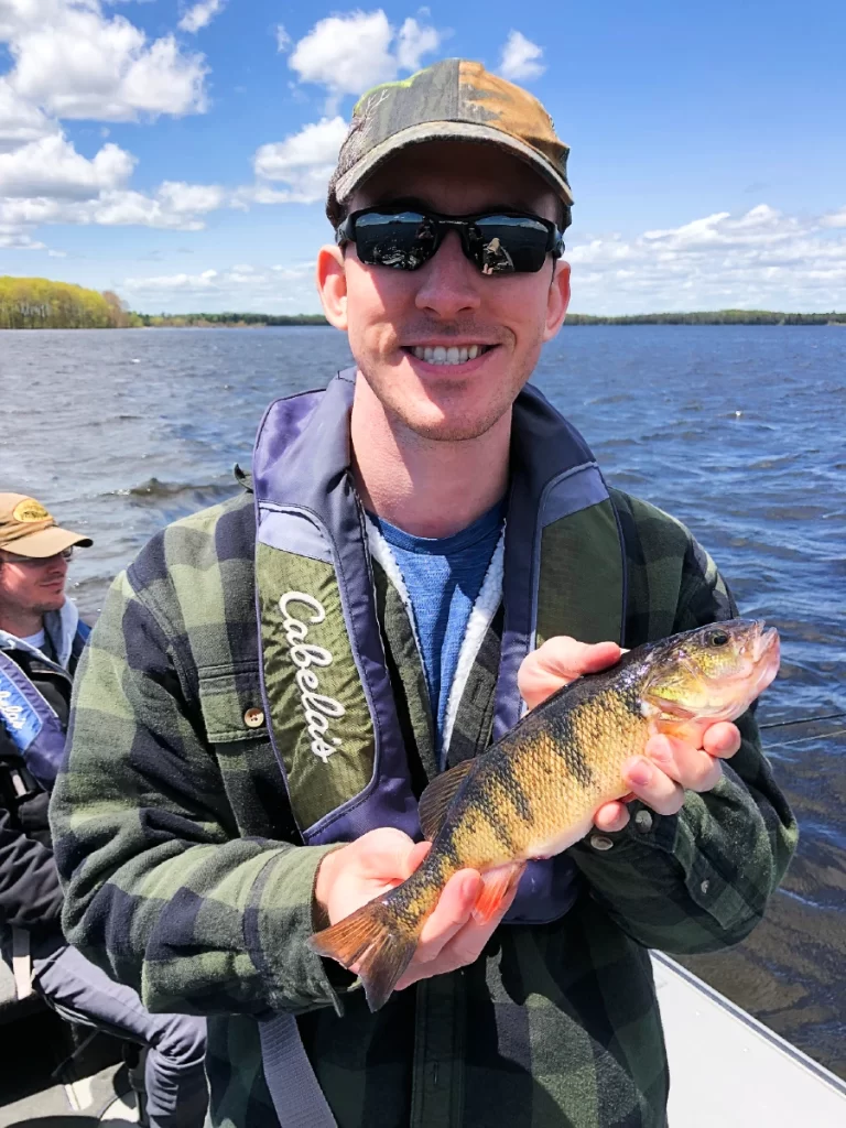 andrew juran holding yellow perch caught with ultralight fishing rod
