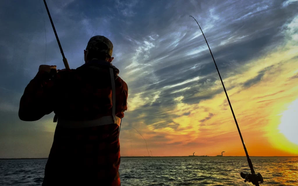 papa juran fishing with Trolling Rods at Sunset on Lake Michigan