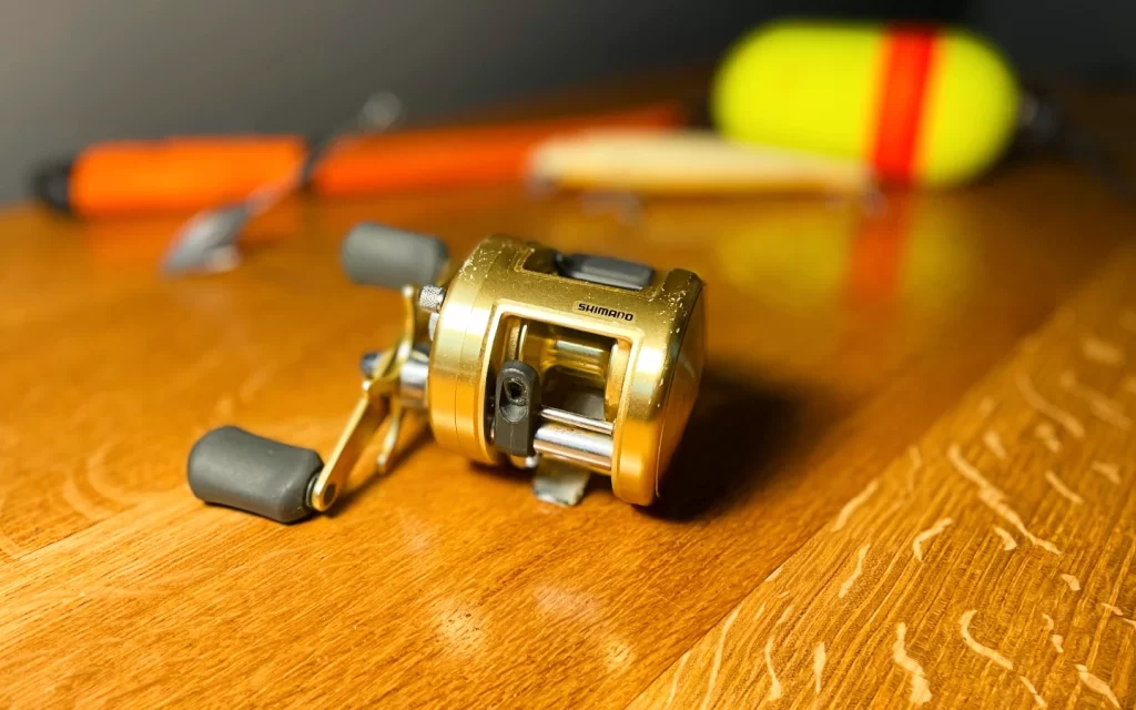 shimano conventional reel on a wooden backdrop