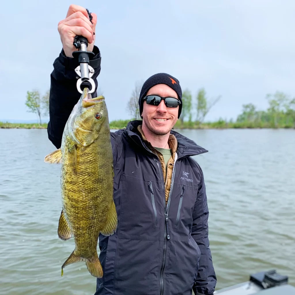 andrew juran holding smallmouth bass caught on lake superior