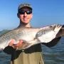 andrew juran holding speckled trout caught with daiwa rod and penn battle III reel