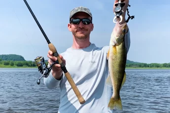 andrew juran holding st croix premier spinning rod with walleye