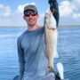 andrew juran holding redfish caught inshore fishing