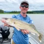 Andrew Juran Holding a walleye on a boat on the mississippi river