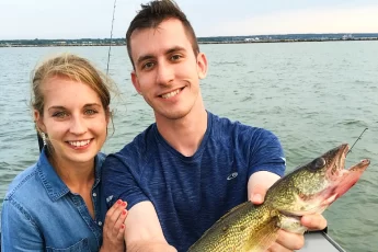 andrew juran and ornella juran holding a walleye fish caught trolling on lake superior