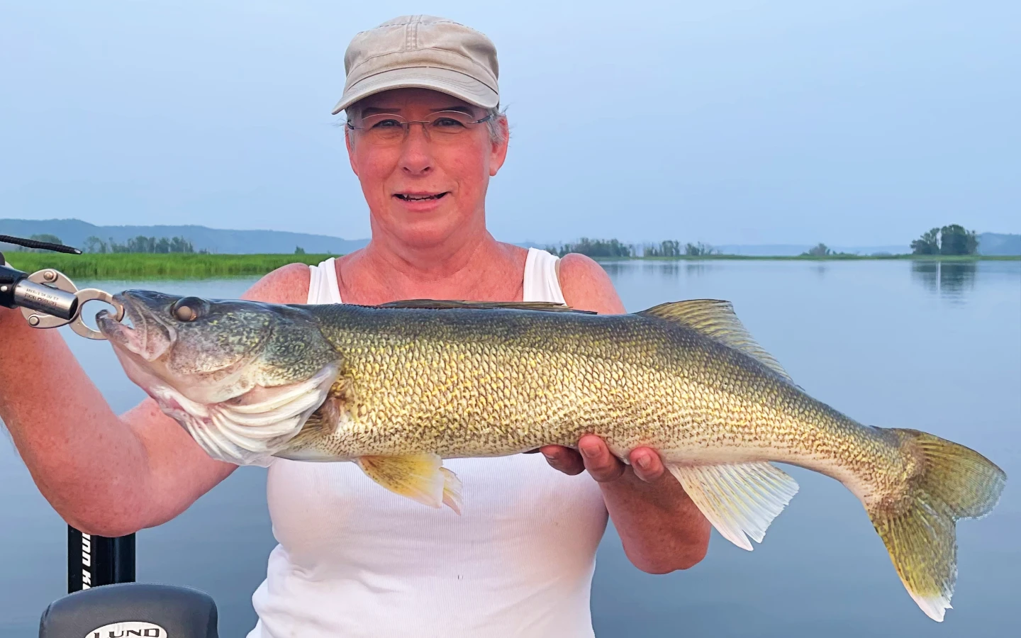mama juran with a huge walleye caught on the mississippi river