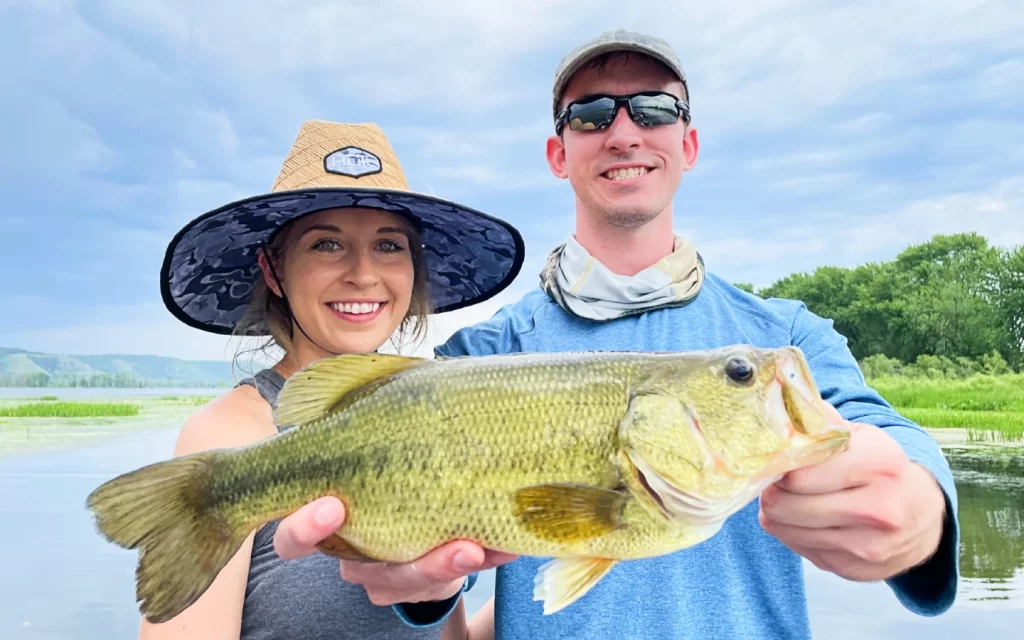 andrew juran and ornella juran holding largemouth bass on mississippi river