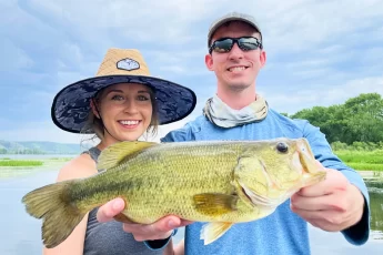 andrew juran and ornella juran holding largemouth bass on mississippi river