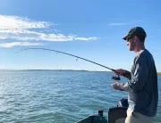 Andrew Juran Fishing in a boat with a 6 foot 6 inch spinning rod and reel