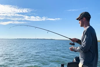 Andrew Juran Fishing in a boat with a 6 foot 6 inch spinning rod and reel