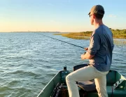 andrew juran fishing out of a small boat during sunrise with a spinning rod
